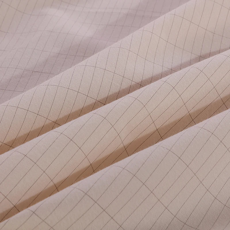 Close-up view of the grounding sheet's fabric, showing the intricate weave of silver fibers that enhance conductivity and effectiveness for grounding purposes.