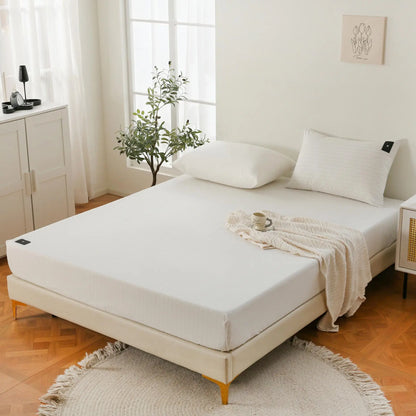 Photo showing a fitted grounding sheet on a twin bed in a well-lit room, emphasizing the sheet’s fine texture and conductive materials